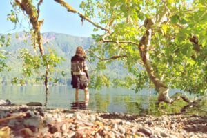 Woman Stepping into Lake