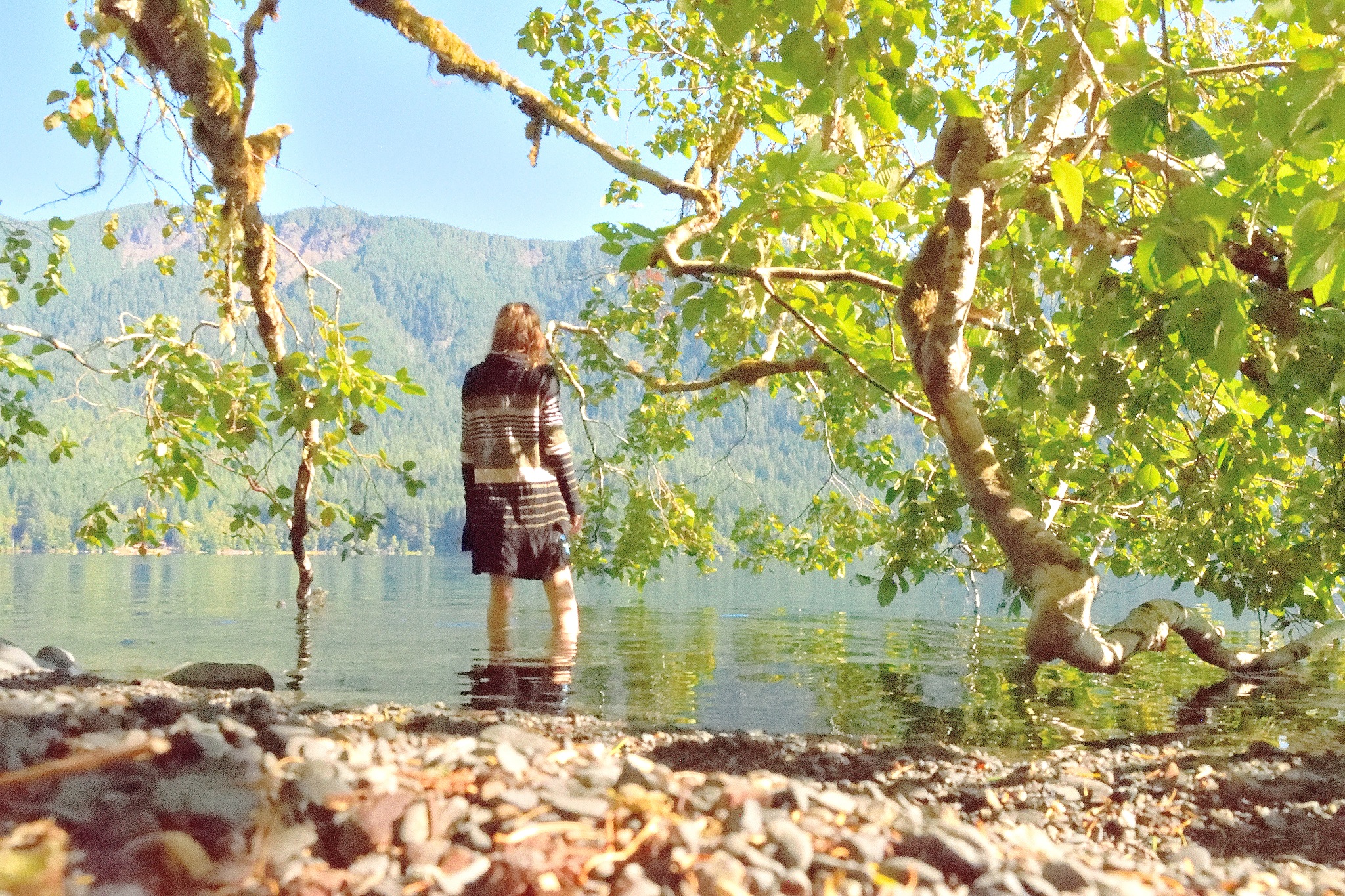 Woman Stepping into Lake